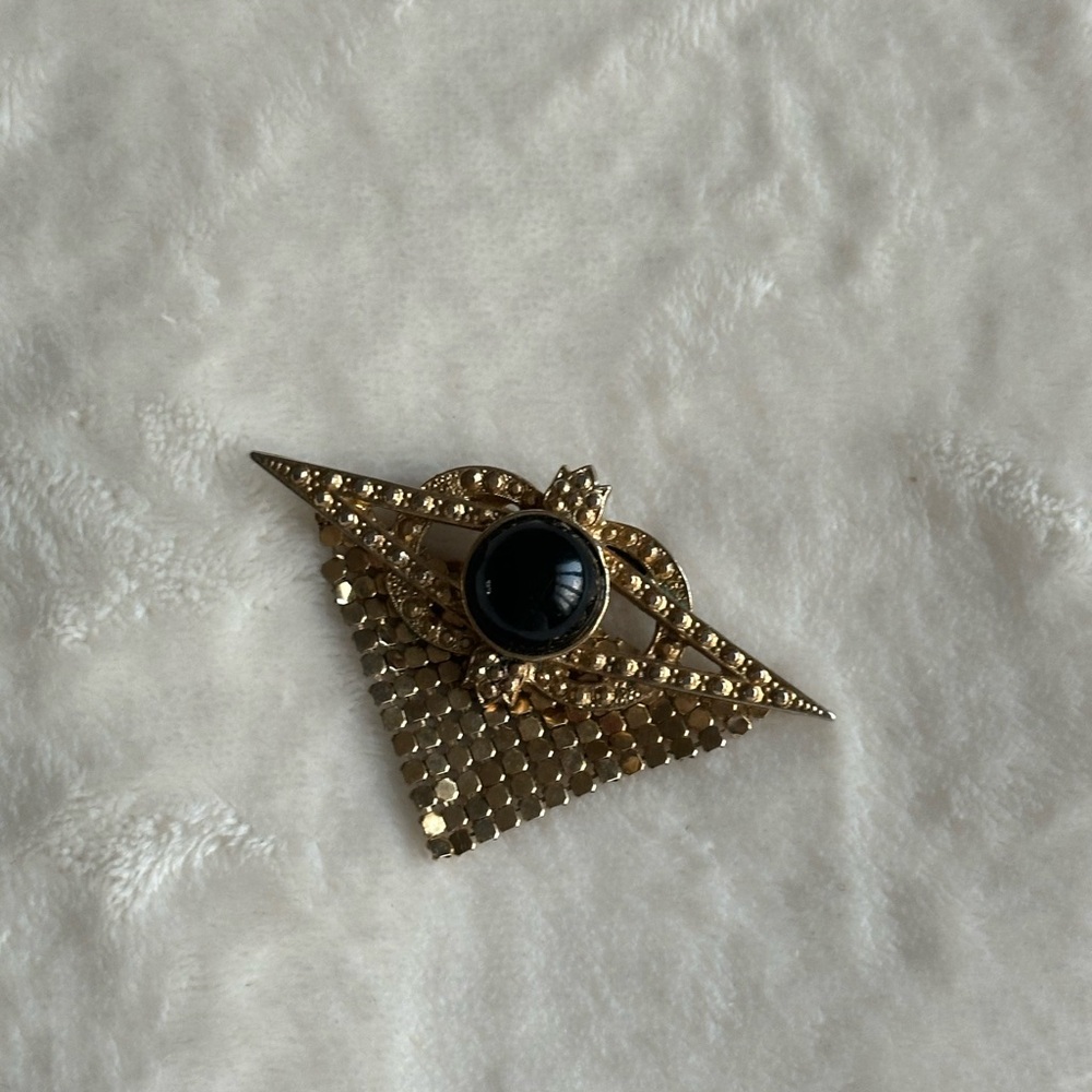 Elegant Gold and Black Brooch